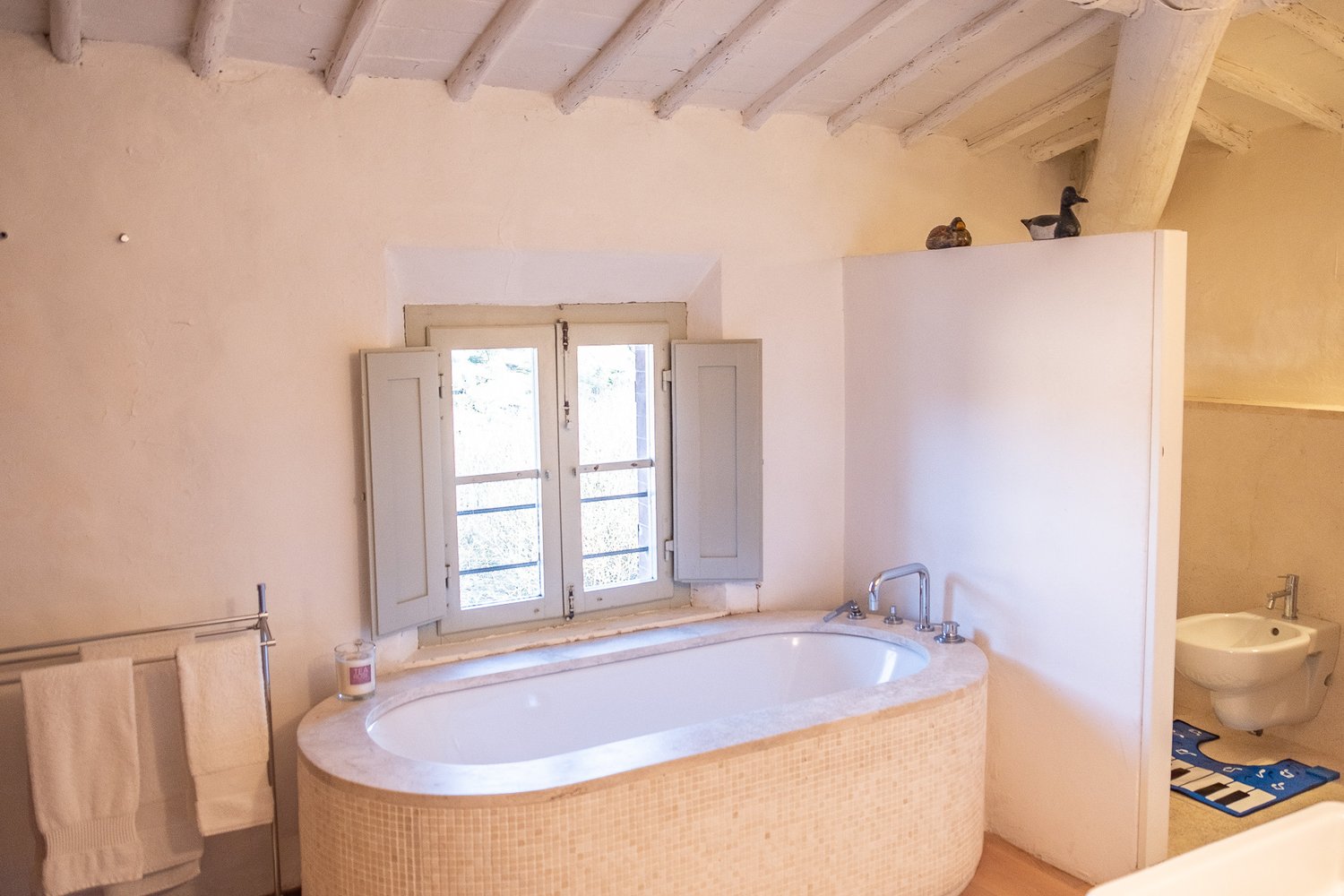 The girls bathroom with  our bath. Quite often I have a bath at night with the candles and I can see the Duomo and the Center of Siena from the window. Just magic.  
